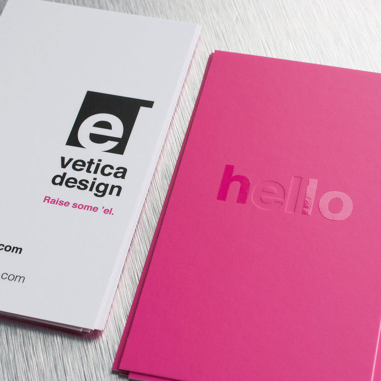 Pink and white business cards showing raised spot gloss and blind-debossed lettering.