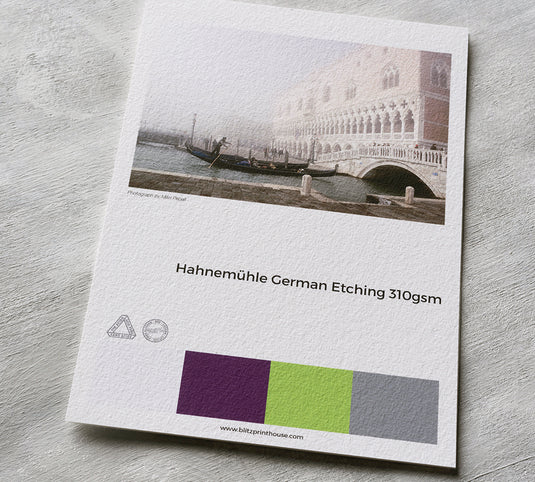Hahnemühle German Etching paper sample with a scenic print and color swatches.