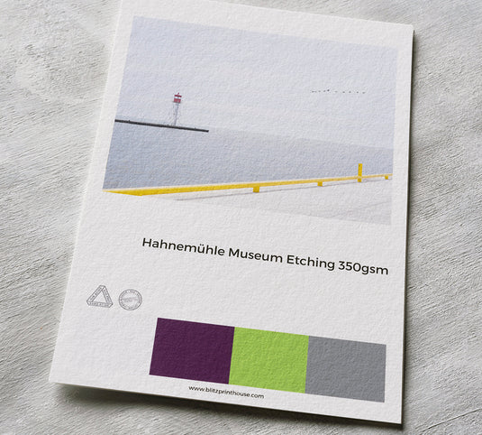 Hahnemühle Museum Etching paper sample with a lighthouse image on a gray surface