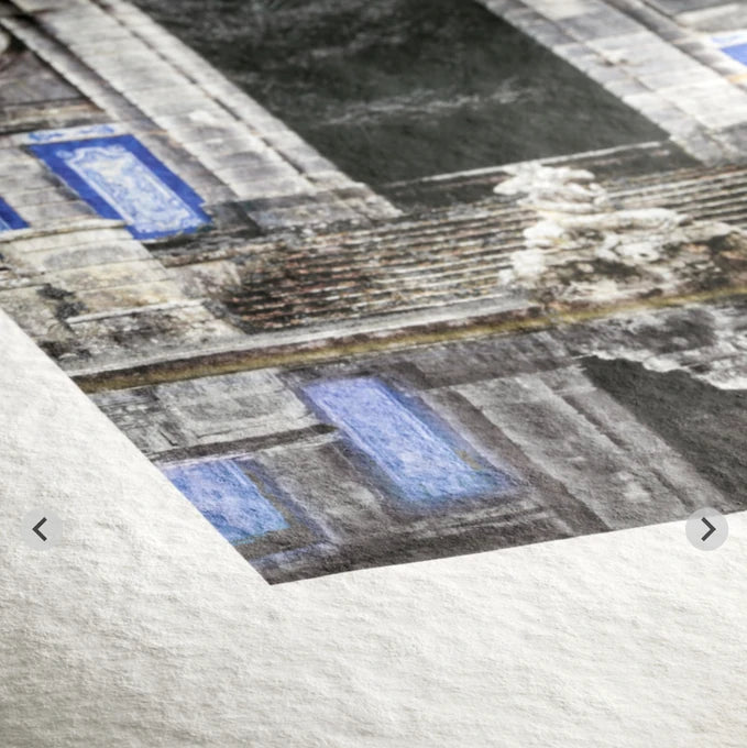 Torchon paper showing a coarse felt texture through a printed building image and bright white margin